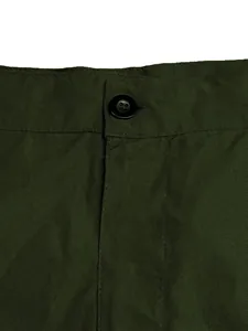 Detailed view of the waist button and olive green fabric texture on men's shorts