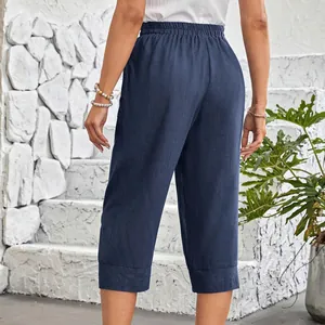 Back view of navy blue loose cotton linen cropped pants with elastic waist and pockets