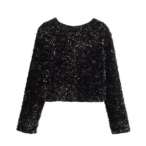 Detailed view of a black sequin long-sleeved cropped jacket with a round neck.