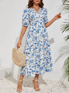Elegant blue floral print midi dress with V-neck and puff sleeves for a summer vacation look