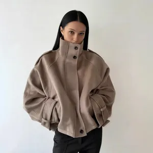Detailed view of taupe stand collar wool coat with single-breasted buttons and oversized fit