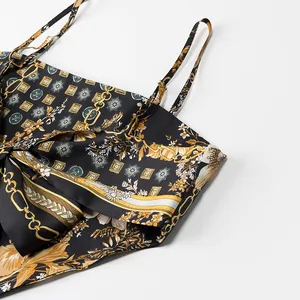 Macro detail of retro printed satin camisole featuring intricate floral and chain patterns