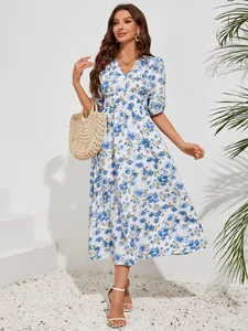 Full view of blue floral print V-neck midi dress with puff sleeves and straw bag