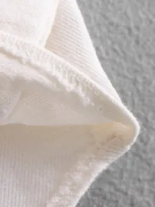 Close-up of high-quality white denim fabric stitching and internal seam detail