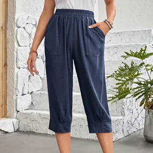 Detail view of navy blue cotton linen loose casual pants with large pockets and elastic waist