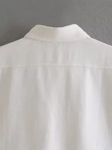 Detailed close-up of white denim jacket collar showing high-quality fabric texture and stitching