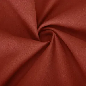 Detailed macro shot of dark rust red breathable cotton linen fabric texture for pants