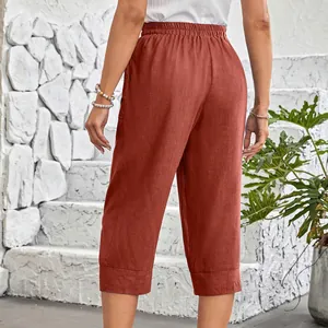 Back view of rust red loose cotton linen cropped pants with elastic waist