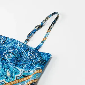 Close-up of blue paisley print satin camisole featuring thin adjustable shoulder straps