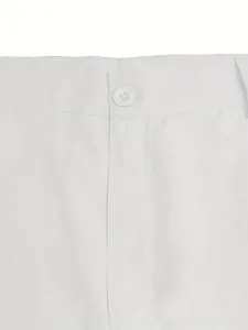 Detailed macro view of the button and waistband on men's white cotton outdoor shorts