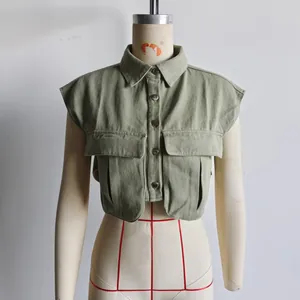 Detailed view of olive green sleeveless cropped denim shirt with large utility pockets