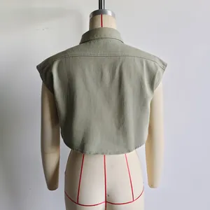 Back view of cropped sleeveless olive green denim shirt with polo collar on mannequin