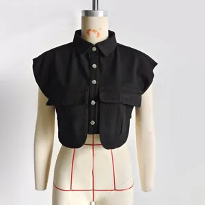 Detail view of a black sleeveless cropped denim-style shirt with polo collar and pockets