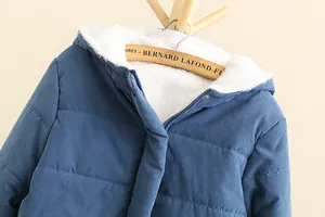 Detailed view of women's blue hooded puffer jacket with soft white fleece lining