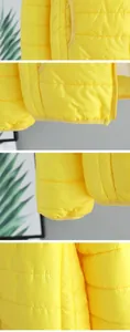 Detailed macro view of yellow lightweight puffer jacket showing stitching, hem, and pockets