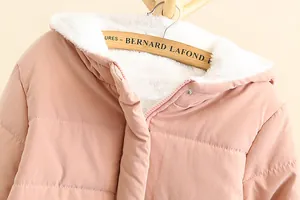 Close-up detail of a pink hooded winter jacket featuring soft warm white fleece lining