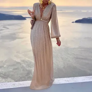 Detail view of the sparkly sequined fabric on this elegant apricot V-neck maxi dress.