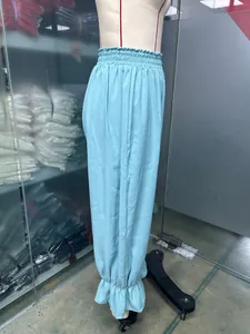 Detail view of light blue cotton linen lantern pants with ruffled hem on mannequin
