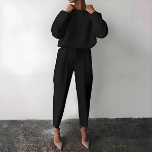 Full view detail of the fit and styling of the black two-piece set for women's autumn wear