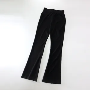 Close-up view of black high-waisted ribbed flare pants with a slim fit silhouette