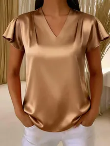Close-up of elegant champagne satin V-neck blouse featuring sophisticated pleated flutter sleeves