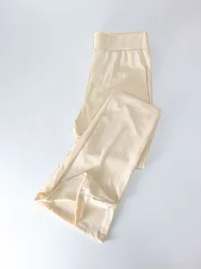 Close-up of beige high-waisted ribbed flare pants showing vertical striped texture