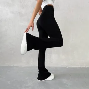 Side view of high waisted black flare pants showing slim fit and ribbed knit texture