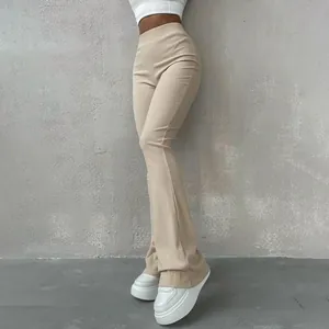 Close-up of beige high-waisted ribbed flare pants for a slim-fit look