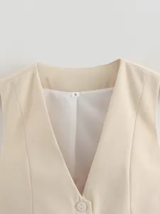 Close-up of beige women's V-neck vest showing collar detail and white lining.