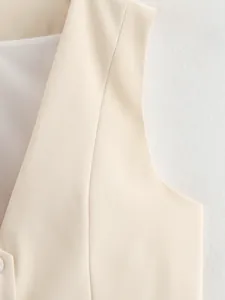 Close-up detail showing the fine twill texture and stitching of this cream women's V-neck vest