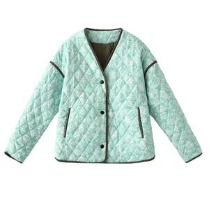 Front view of women's mint green V-neck quilted jacket with white floral paisley print