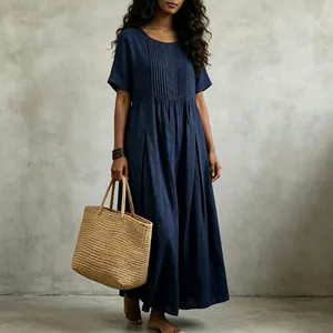 Close-up detail of a navy blue cotton linen pleated maxi dress featuring a relaxed casual fit