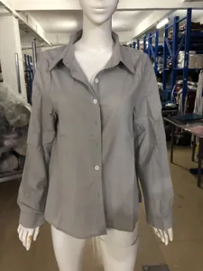 Detailed view of a solid grey casual long-sleeved linen shirt displayed on a mannequin