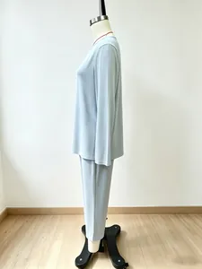 Detailed side view of a light blue two-piece long-sleeved top and trousers set on a mannequin