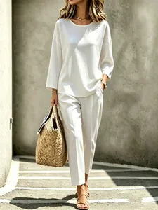 Full body shot of a stylish white urban two-piece set with long sleeves and trousers
