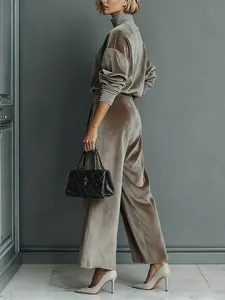 Full body detail of a taupe velvet tracksuit set with turtleneck and wide leg pants