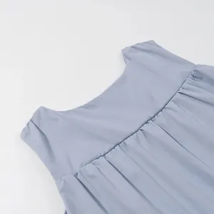 Close-up of the pleated detail and round neckline of a solid blue sleeveless top.