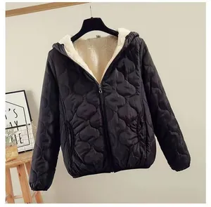 Detail view of black wave-quilted hooded jacket with cozy white fleece lining