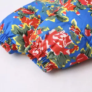 Detailed view of elastic cuffs on a blue floral print puffer jacket for women.