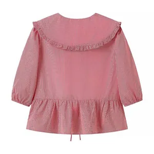 Back view of a red and white gingham blouse with a large ruffled Peter Pan collar.