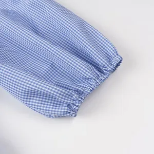 Detail of elasticated sleeve cuff on blue and white gingham checkered shirt for women