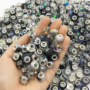 Hand holding mixed colors large hole beads for DIY charm bracelet jewelry making