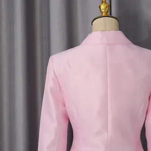 Macro view of the back of a luxury pink satin blazer with elegant tailoring.