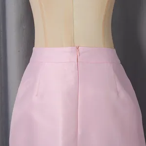 Detailed view showing the invisible zipper on a luxury pink satin formal skirt
