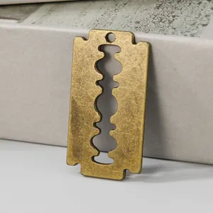 Vintage bronze alloy razor blade pendant for DIY jewelry making close-up detail view