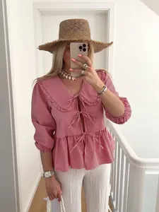 Chic women's red and white gingham blouse with a doll collar and front tie detail