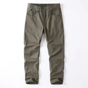 Men's retro olive green workwear pants in washed cotton with straight leg design.