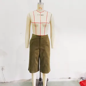 Detailed front view of olive green faux suede shorts displayed on a professional mannequin