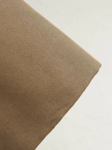 Close-up of durable twill fabric texture in khaki for women's autumn trench coat