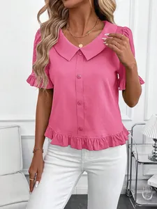 Detailed view of pink short sleeve blouse with ruffle hem and Peter Pan collar